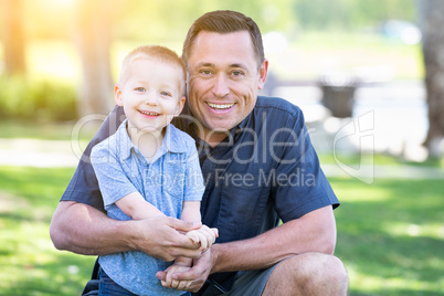 Young Caucasian Father and Son Having Fun At The Park