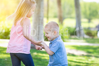 Young Brother and Sister Playing At The Park Togther