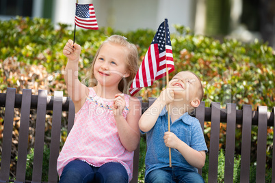 Young Sister and Brother Comparing Each Others American Flag Siz