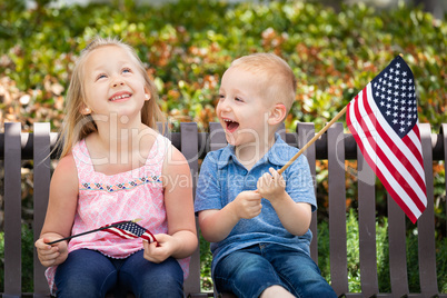 Young Sister and Brother Comparing Each Others American Flag Siz