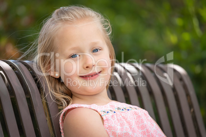 Pretty Young Caucasian Girl Portrait Sitting On The Bench At The