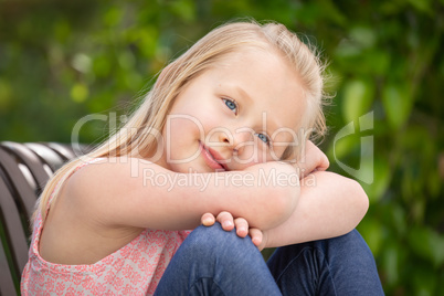 Pretty Young Caucasian Girl Portrait Sitting On The Bench At The