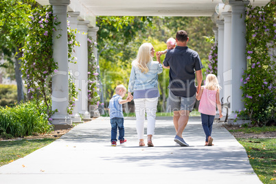 Young Caucasian Family Taking A Walk In The Park