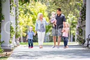 Young Caucasian Family Taking A Walk In The Park