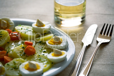 Boiled eggs with potatoes and carrots