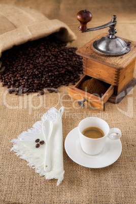 Coffee with mill and beans on jute