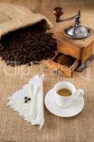 Coffee with mill and beans on jute