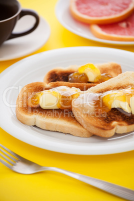 French toast with sliced orange fruit on yellow tablecloth