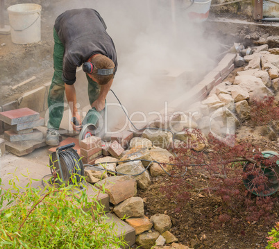 Craftsman works with an electric grinding machine