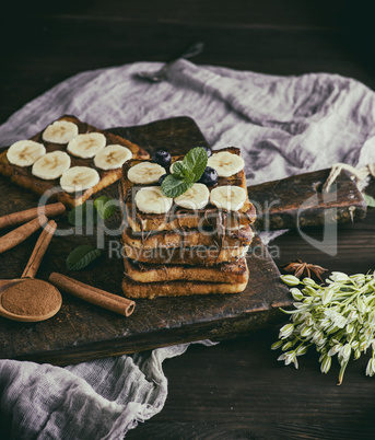 square French toasts of white bread with chocolate and pieces of