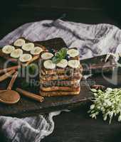 square French toasts of white bread with chocolate and pieces of