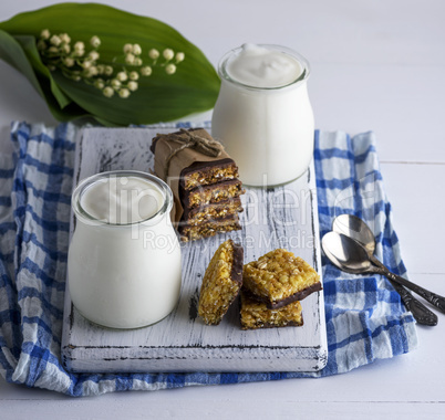 two jars with homemade yogurt and snacks from muesli