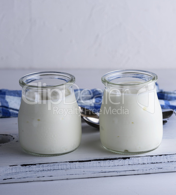 homemade yogurt in a glass jar on a white wooden board