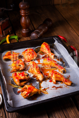 Rustic backed chicken wings,legs on baking tray