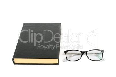 Book and glasses isolated on white background. Free space for te