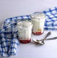 two glass glasses with homemade yogurt and raspberry syrup