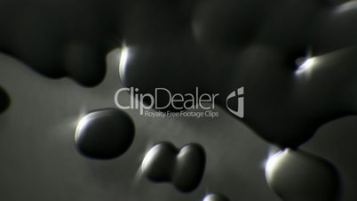 Black oil droplets close up falling down slow motion