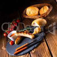 rustic bratwurst with ketchup and fresh rolls