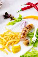 delicious grilled bratwurst with fries and mustard