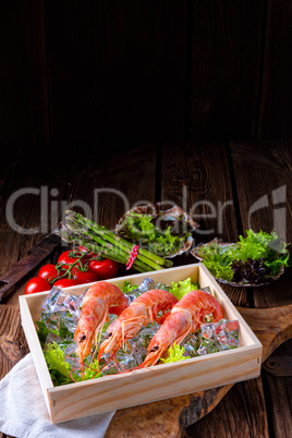 cooked argentine red prawns with salad on the ice