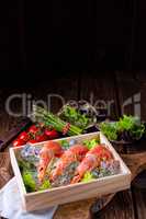 cooked argentine red prawns with salad on the ice
