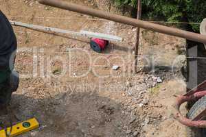 Man is laying paving stones.