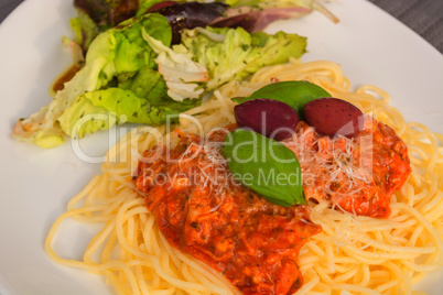 Spaghetti Bolognese with basil leaf