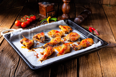 Rustic backed chicken wings,legs on baking tray