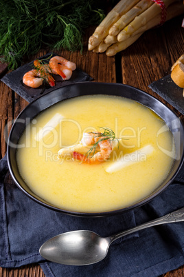 delicious asparagus cream soup with prawns and fresh dill