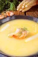 delicious asparagus cream soup with prawns and fresh dill