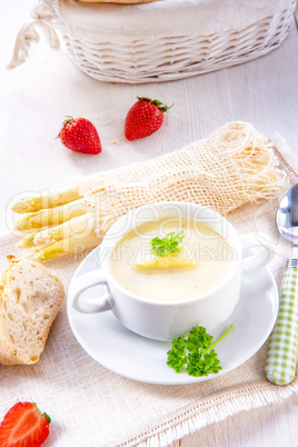 asparagus cream soup with capers and fresh baguette