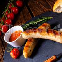 rustic bratwurst with ketchup and fresh rolls