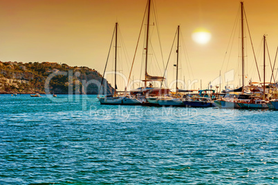 Sunset over a mediterranean bay with marina