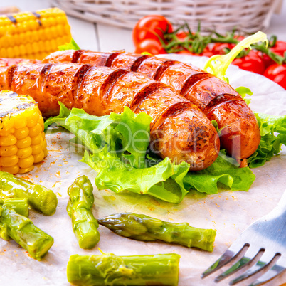 grilled krakauer sausage with boiled corn and green salad