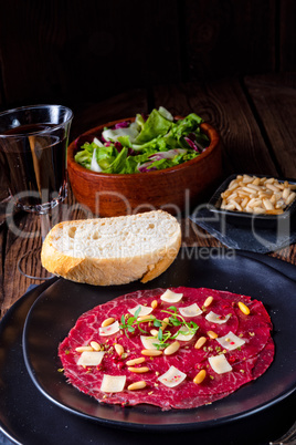 Carpaccio of beef with pine nuts, colorful pepper and Parmesan c