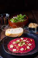 Carpaccio of beef with pine nuts, colorful pepper and Parmesan c