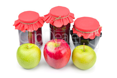 Apple jam in a glass jar, fresh red and green apples isolated on