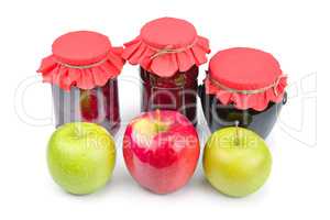 Apple jam in a glass jar, fresh red and green apples isolated on