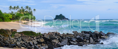 Ocean, picturesque beach and blue sky. Wide photo.