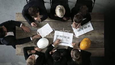 Business people with construction blueprint