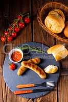 rustic bratwurst with ketchup and fresh rolls