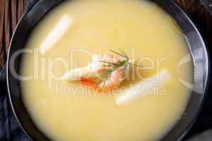 delicious asparagus cream soup with prawns and fresh dill