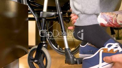Helping a disabled man in wheelchair closeup