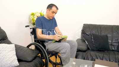 Melancholic sad young disabled man looking at a photo