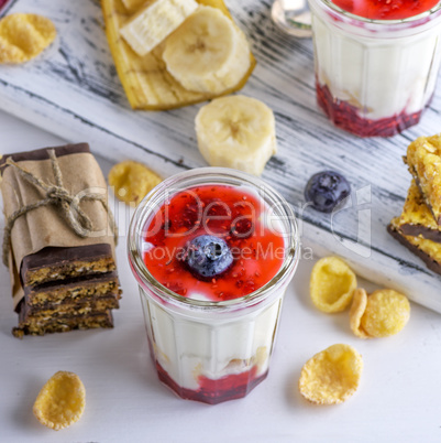 yogurt in transparent glass with syrup and banana