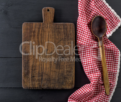 empty old wooden cutting board and a wooden spoon