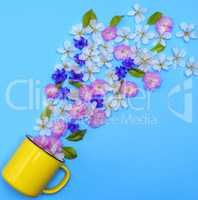 yellow ceramic mug and buds of flowers