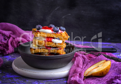 French toast with berries, syrup and sour cream