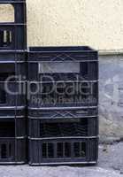 stack of empty black plastic crates