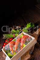 cooked argentine red prawns with salad on the ice